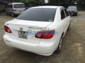 Cần bán xe Toyota Corolla J, màu trắng, sản xuất năm 2003