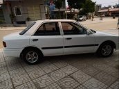 Cần bán gấp Mazda 323 đời 1995, màu trắng, đèn trước sau mới thay, về chỉ việc đi