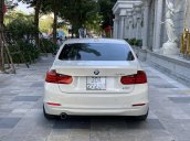 Bán BMW 320i 2014 trắng kem 26000km siêu mới