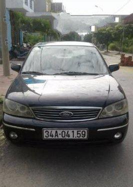 Mình cần bán xe Ford Laser MT đời 2004, màu đen số sàn