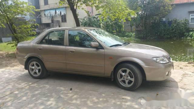 Bán Mazda 323 năm sản xuất 2002, màu vàng cát