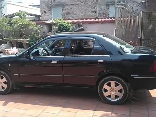 Gia đình bán Ford Laser GHIA 1.8 MT đời 2003, màu đen0