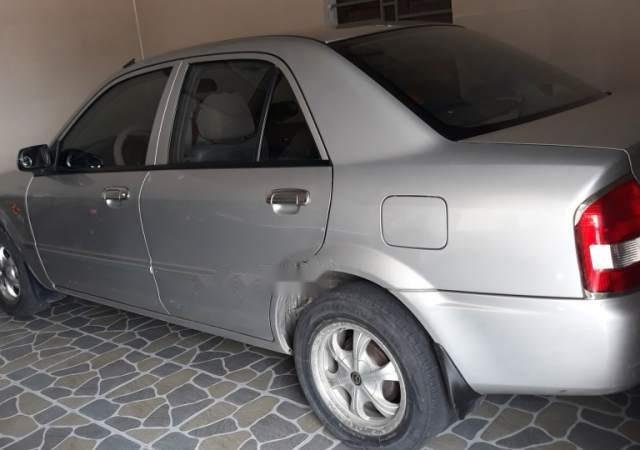 Cần đổi xe tự động bán Mazda 323 đời 2003, màu bạc