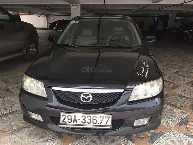 Cần bán lại xe Mazda 323 đời 2003, màu đen xe còn chạy êm0