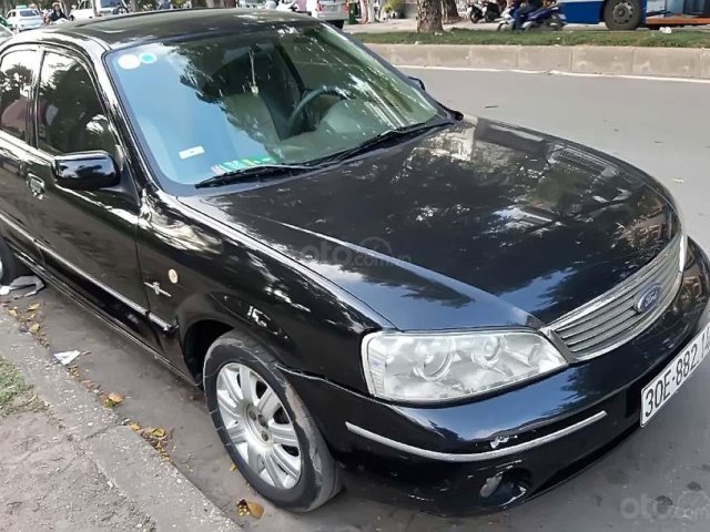 Cần bán gấp Ford Laser GHIA 1.8 AT năm sản xuất 2004, màu đen chính chủ 0