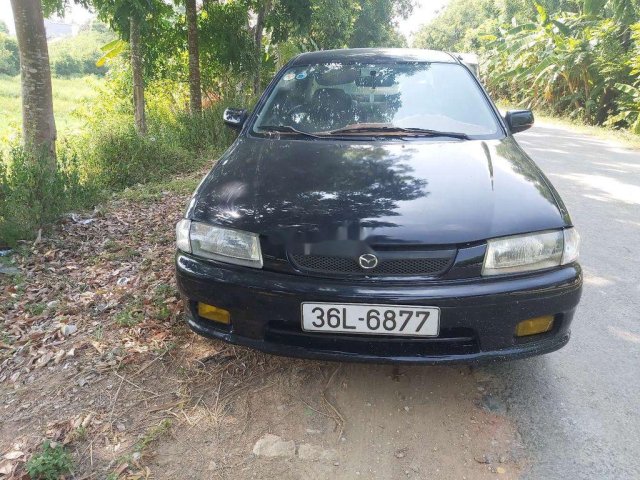 Bán Mazda 323 năm sản xuất 2000, màu đen còn mới, giá 79tr0