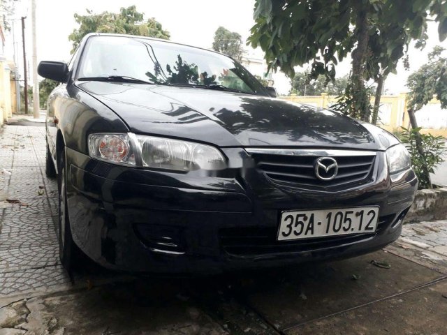 Cần bán lại xe Mazda 323 2004, màu đen, xe nhập còn mới0