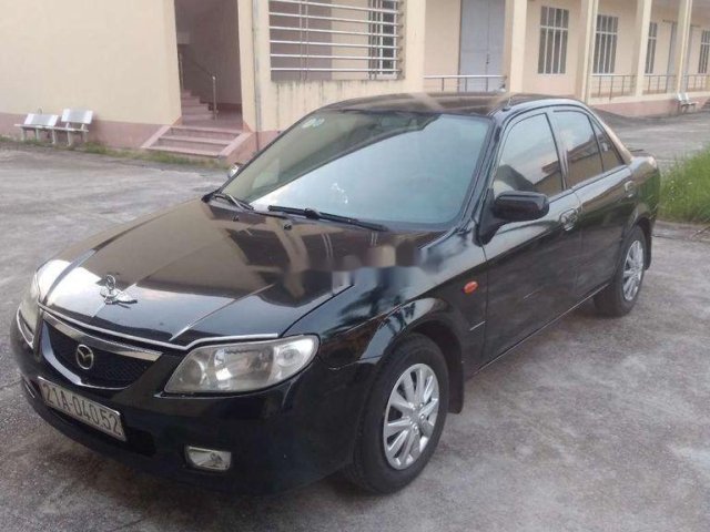 Cần bán Mazda 323 năm 2002, màu đen0