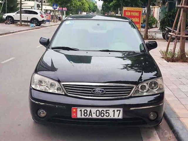 Cần bán xe Ford Laser Ghia 1.8 MT sản xuất năm 2003, màu đen, giá cạnh tranh0