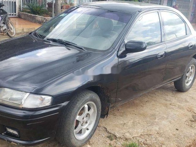 Cần bán xe Mazda 323 sản xuất năm 1998, màu đen0