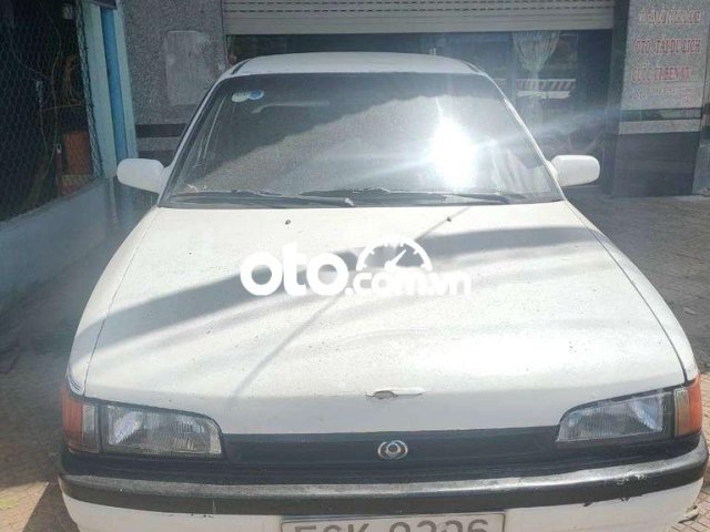 Bán ô tô Mazda 323 sản xuất 1995, màu trắng, nhập khẩu